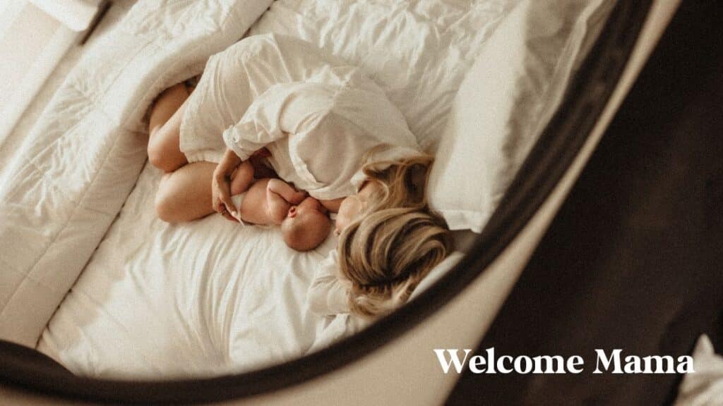 mom laying in bed with newborn