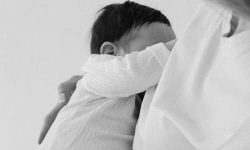 baby with hair full of head breastfeeding