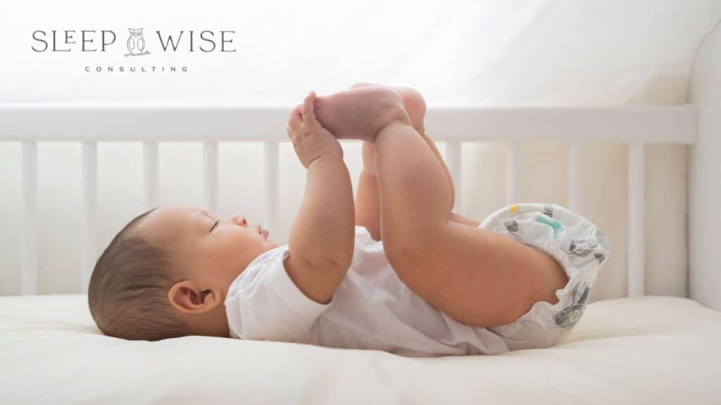 Baby Laying in Crib on How to Sleep Train a 6 Month Old