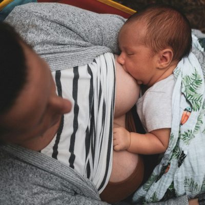 overhead of a mother breastfeeding a newborn